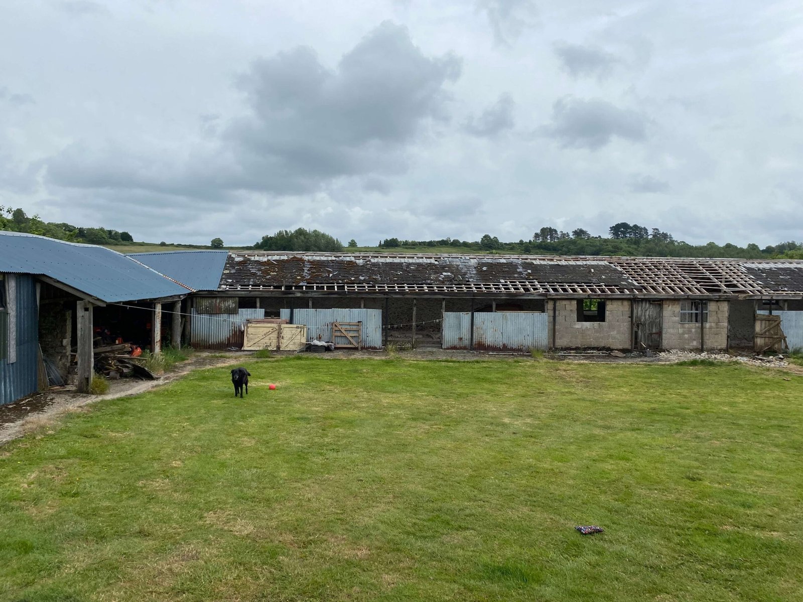 Barn conversion before renovation in Uplyme showing original agricultural buildings